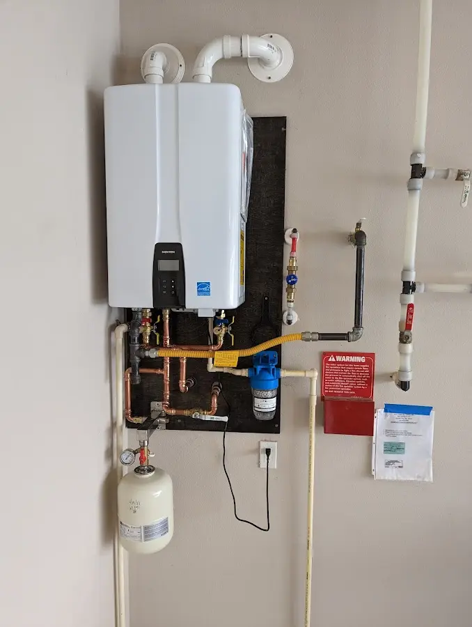 Professional plumber installing copper piping in a Saxon home
